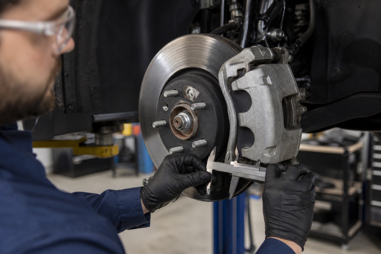 Close inspection of a vehicle brake rotor and caliper